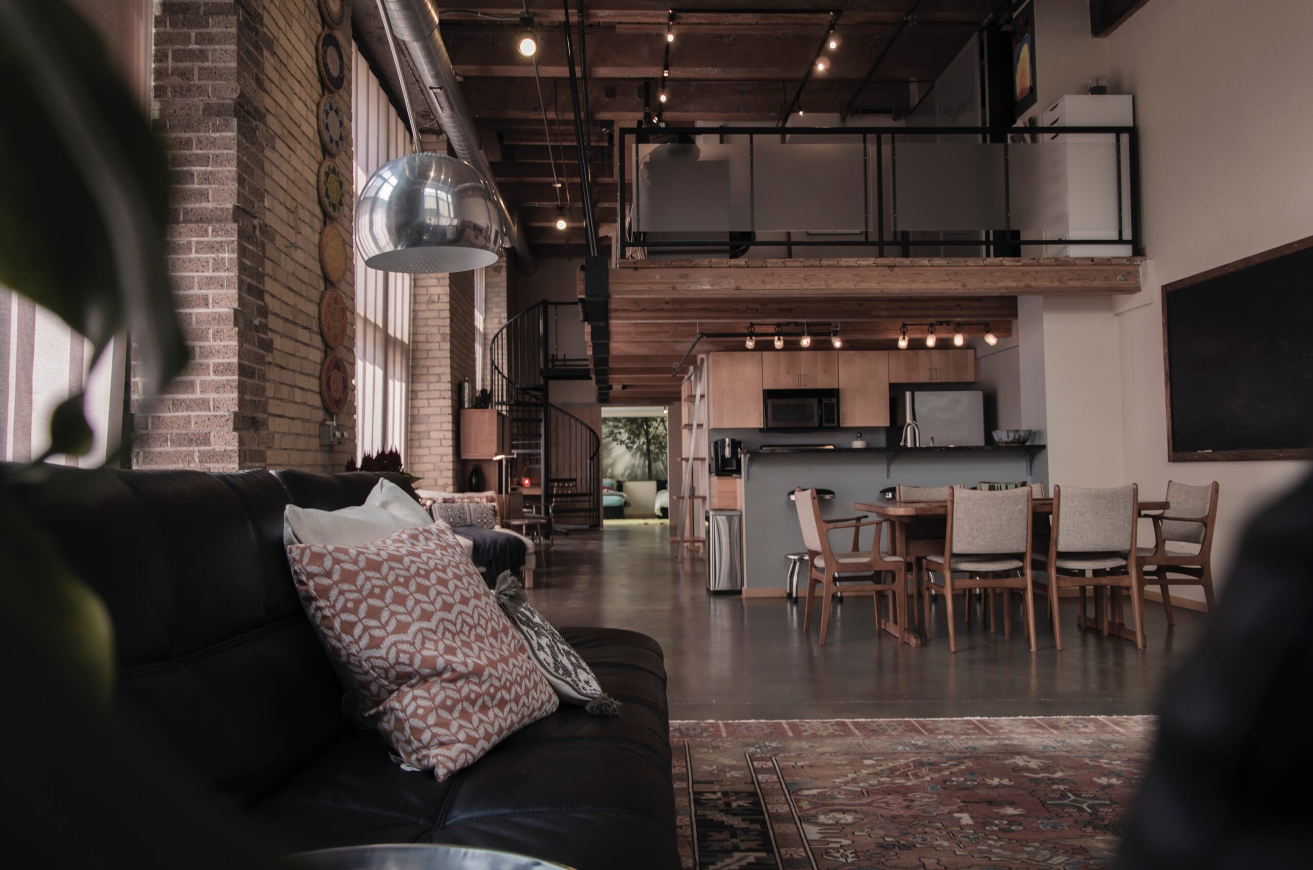 Dark and moody loft-style home interior, featuring industrial design elements with sophisticated, atmospheric lighting, creating an intimate urban living space in Calgary.