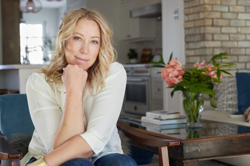 Lesley Hauville, experienced Calgary real estate agent, relaxing in the elegant living room of a property available for sale in Calgary, Alberta.